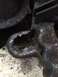 1995 Ford Bronco - This close-up shows a damaged, rusted metal bracket with a hole, likely a vehicle part.