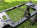 1995 Ford Bronco - A vehicle frame, likely a radiator support, is shown outdoors on sawhorses.