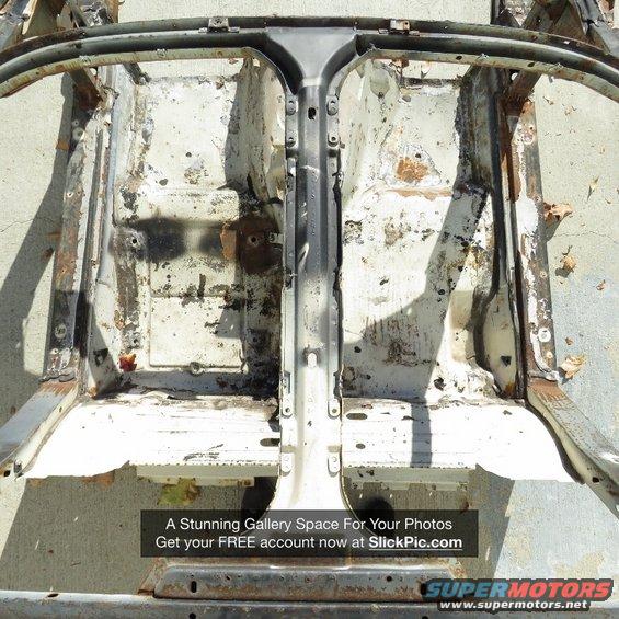 Corroded car chassis and frame, showing interior floor pan structure