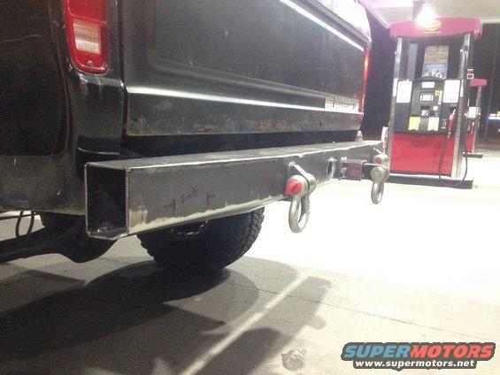 Black 1979 Ford Bronco rear with custom steel bumper and red tow hooks
