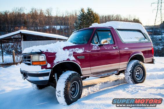 Red 1995 Ford Bronco in snow