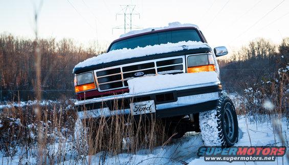 Red 1995 Ford Bronco front view in snow