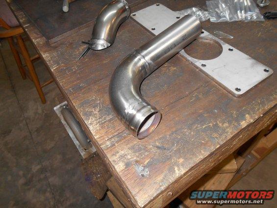 Exhaust pipe and mounting plate on workbench