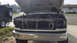 1992 Ford Bronco - Front end of a Ford F-Series truck is disassembled for repairs, showing the grille and engine bay.