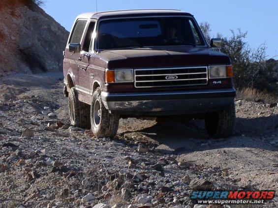 Maroon 1990 Ford Bronco 4x4 on rocky trail