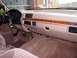 1996 Ford Bronco - The interior of a 1996 Ford Bronco shows its dashboard with wood grain trim and an Eddie Bauer badge.