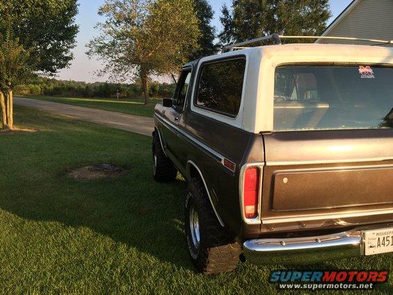 Rear view of a 1978 Ford Bronco with a white top and brown body