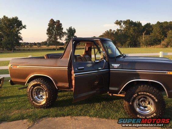 Brown 1978 Ford Bronco with doors open, parked on grass