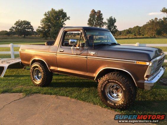 Brown 1978 Ford Bronco parked on grass with a trailer hitch