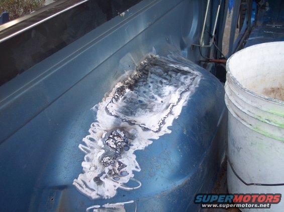 Welded patch on blue vehicle interior wheel well