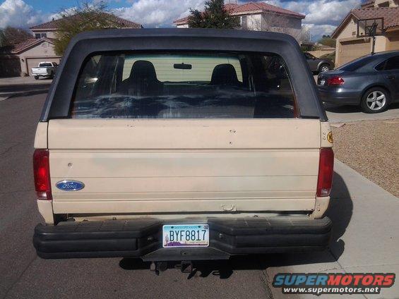 Tan 1992 Ford Bronco rear view with black bumper and tinted windows