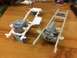1989 Ford Bronco - Model car chassis and engines are laid out on a wooden workbench, ready for assembly.