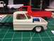 1989 Ford Bronco - Model truck parts, including a cab and engine, are laid out on a cutting mat.