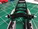 1989 Ford Bronco - A model truck chassis is shown with its suspension components assembled on a green cutting mat.