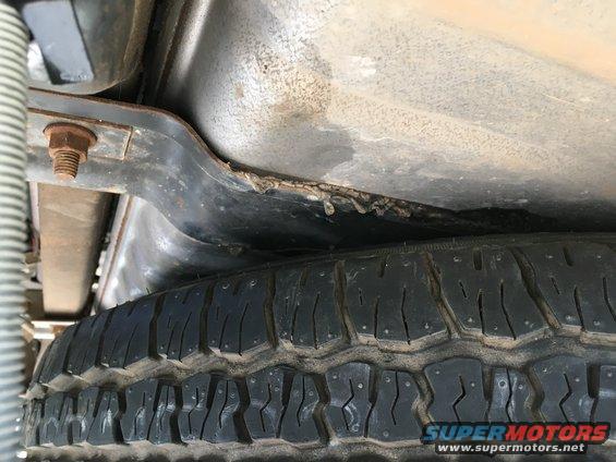 Black gunk on fuel tank straps.
