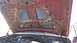 1996 Ford Bronco - The underside of a red hood reveals louvers and engine parts, with the Supermotors logo visible at the bottom right.