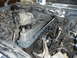 1995 Ford F-150 - Engine bay of a 1995 Ford F-150 with the valve cover removed for maintenance or repair.