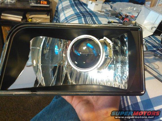 kimg0090.jpg the projector inside the housing without the shroud.

before you do final install, make sure the projector is right side up. the lens flips the beam upside down so the flap for the high beam needs to actually be on the bottom.

it would be good to test the assembly before final install to make sure it is correct. luckily i did test it and caught it