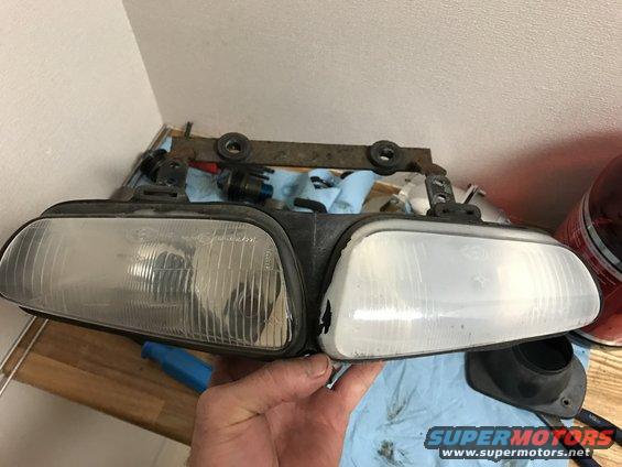 Motorcycle headlight assembly with two clear lenses, one showing vertical fluting