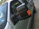 2004 Ford F-150 - Close-up view of a truck's side mirror and door panel, showing a registration sticker on the windshield.