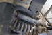 1986 Ford Bronco - This image shows the underside of a vehicle, focusing on the suspension system's coil spring and shock absorber.