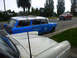 1969 Lincoln Continental - A blue station wagon with a roof rack is parked on the side of the road next to a white car.