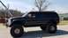 2000 Ford Excursion - This modified Ford Excursion features a significant lift kit and oversized tires.