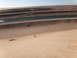 1900 Honda Big Red - A dirt bike rider navigates a sandy dune in a desert environment with a prominent canal in the background.