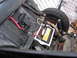 1964 Volkswagen Beetle - The interior of a car displays a battery, wiring, and a spare tire, with visible text from SuperMotors.net.