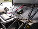 1964 Volkswagen Beetle - Close-up view of a car battery and its associated wiring, with another vehicle visible in the background.