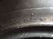2014 Ford F-150 - Close-up of a tire sidewall showing DOT markings and a website logo.