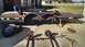 2016 Ford F-250 - Disassembled trailer axles and wheels are laid out on a concrete driveway next to a trailer.