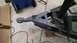 2016 Ford F-250 - A trailer hitch assembly is shown with a gray coupler, chains, and wiring, alongside a rotary tool on a concrete surface.
