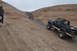 1991 Ford Bronco - Ford Bronco navigates a challenging off-road trail in a desert landscape.