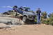 1991 Ford Bronco - A two-tone Ford Bronco navigates a rocky trail with another vehicle in the background.