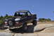 1991 Ford Bronco - This 1991 Ford Bronco is navigating a rocky trail with a clear blue sky overhead.