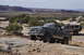 1991 Ford Bronco - Two off-road vehicles, a Ford Bronco and a Jeep Wrangler, traverse a desert landscape.