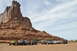 1991 Ford Bronco - Off-road vehicles gathered in a desert landscape with prominent rock formations under a cloudy sky.