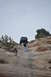 1991 Ford Bronco - Jeep Wrangler being lifted by a person on a rocky trail.