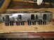 1964 Ford Galaxie - Engine cylinder head with valve springs shown on a wooden surface.