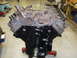 1964 Ford Galaxie - A V8 engine block is shown, partially assembled, in a workshop setting.