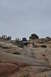 1991 Ford Bronco - Two off-road vehicles navigate a steep, rocky incline under an overcast sky.