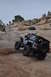 1991 Ford Bronco - A gray Jeep Wrangler navigates a steep, rocky off-road trail with people watching from above.