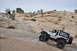 1991 Ford Bronco - A silver Jeep Wrangler navigates a challenging off-road trail in a desert landscape.