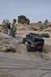 1991 Ford Bronco - Off-road vehicle navigates challenging rocky terrain with spectators observing the ascent.