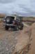 1991 Ford Bronco - Ford Bronco navigates a challenging off-road path in a desert landscape.