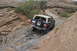 1991 Ford Bronco - A 1991 Ford Bronco tackles a challenging rocky incline on an off-road trail.