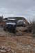 1991 Ford Bronco - Two off-road vehicles, a 1991 Ford Bronco and a Jeep Wrangler, navigate a rocky path.