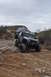 1991 Ford Bronco - Two modified off-road vehicles, a 1991 Ford Bronco and a Jeep Wrangler, navigate a challenging rocky terrain.