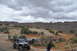 1991 Ford Bronco - Several off-road vehicles, including a 1991 Ford Bronco, navigate a desert trail.